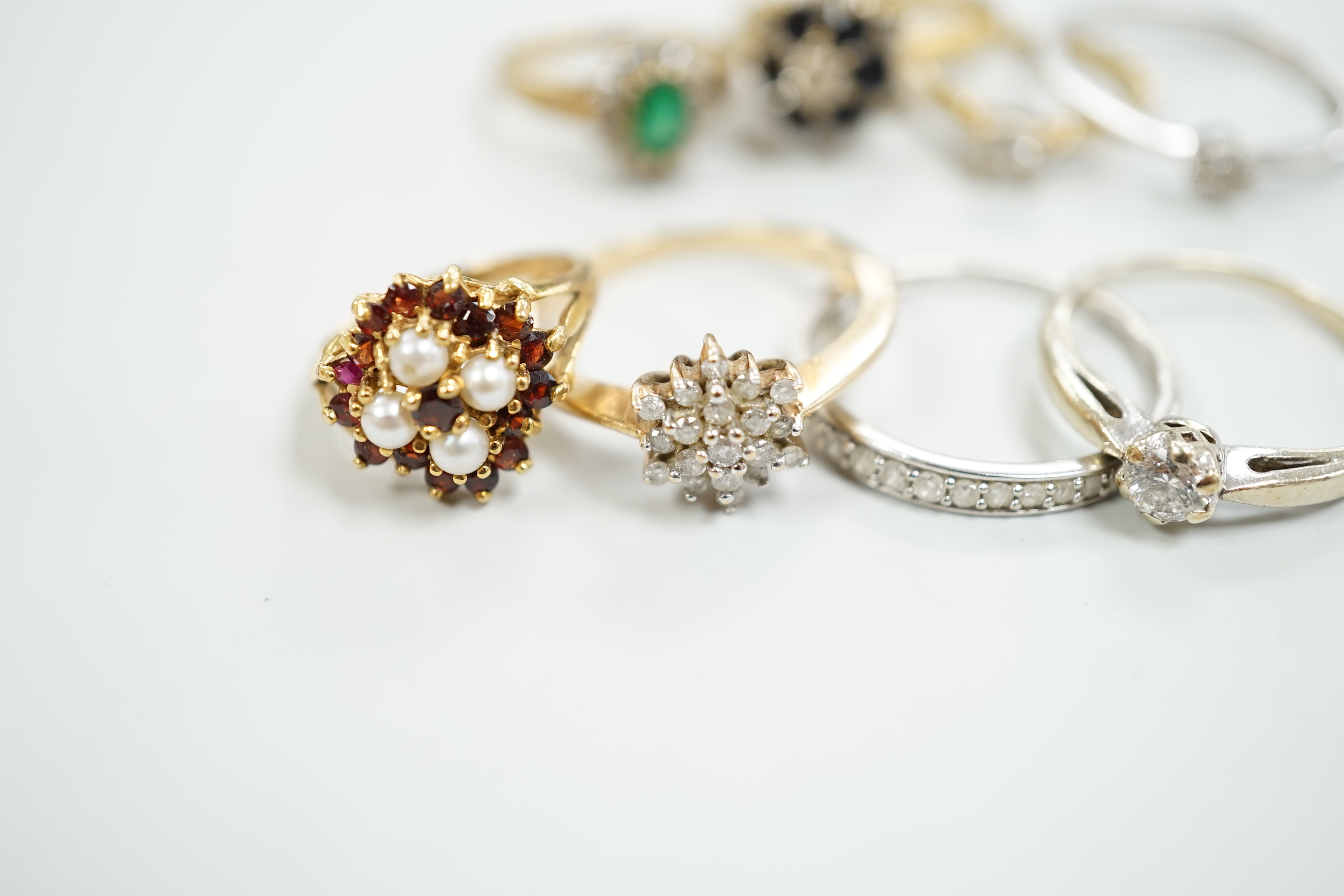 Eight assorted mainly modern 9ct gold and gem set rings, including solitaire diamond and diamond chip half eternity, gross weight 18.8 grams.